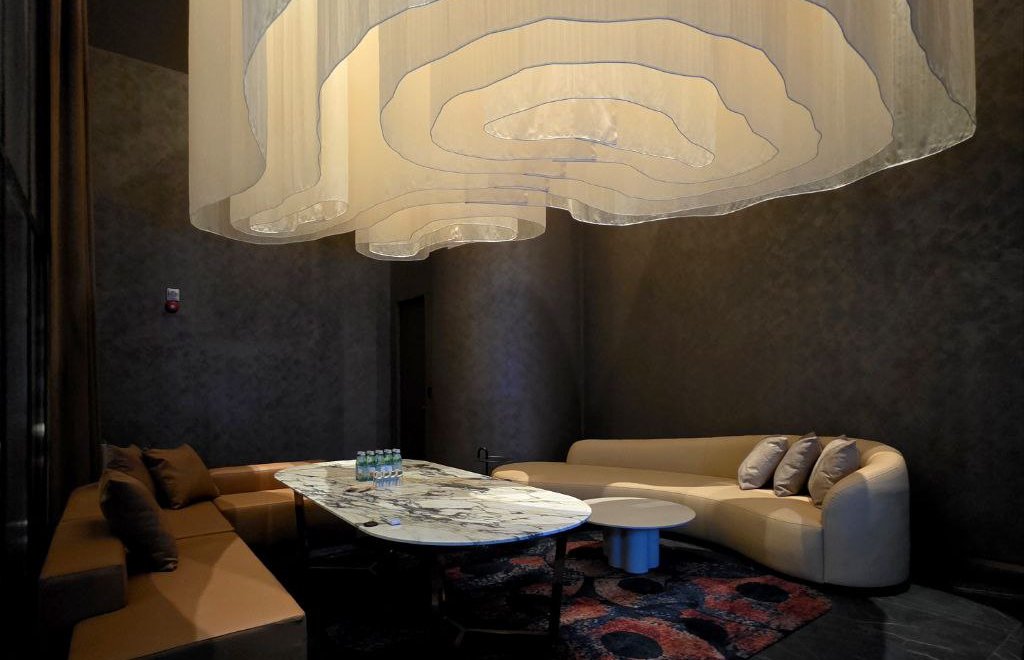 A high-end private karaoke room with premium seating, rich lighting, and an intimate atmosphere designed for VIP guests before and after arena events.