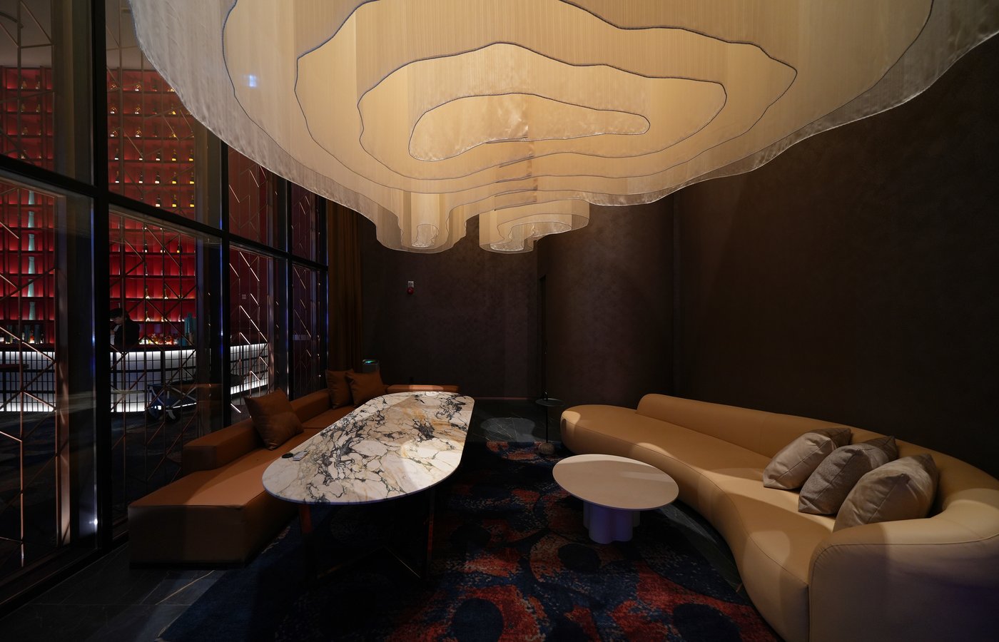 A private lounge room at Ultra Lounge, featuring karaoke, sculptural seating, marble tables, and soft ambient lighting designed for intimate gatherings and exclusive hosting.