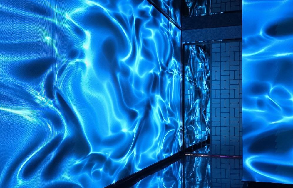 A glowing blue tunnel of liquid light—your first step into the Ultra Lounge experience.